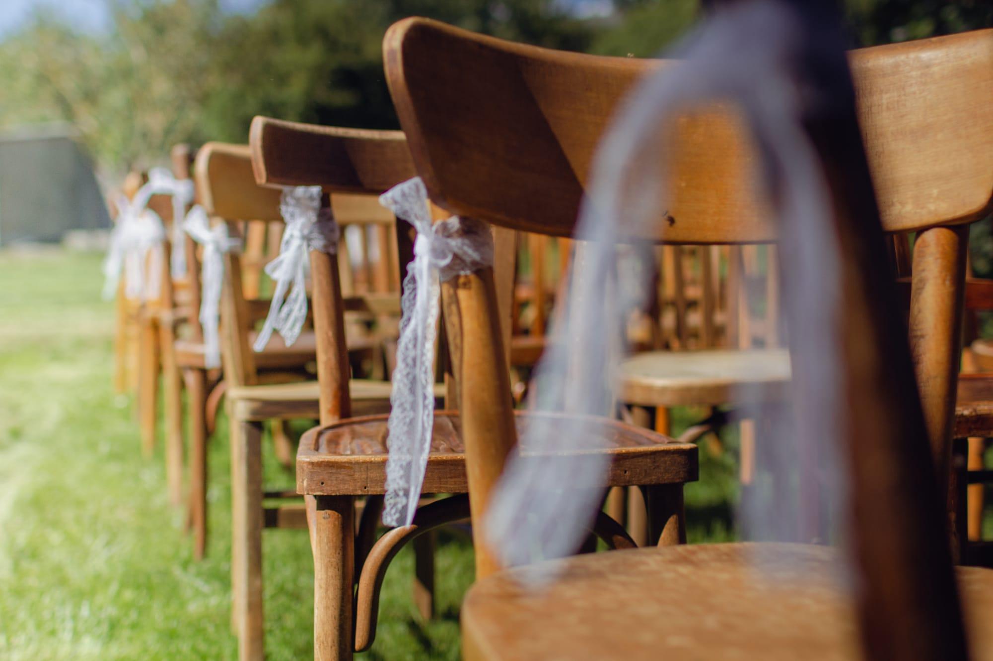 Wooden bistro chairs tied with tulle bows
