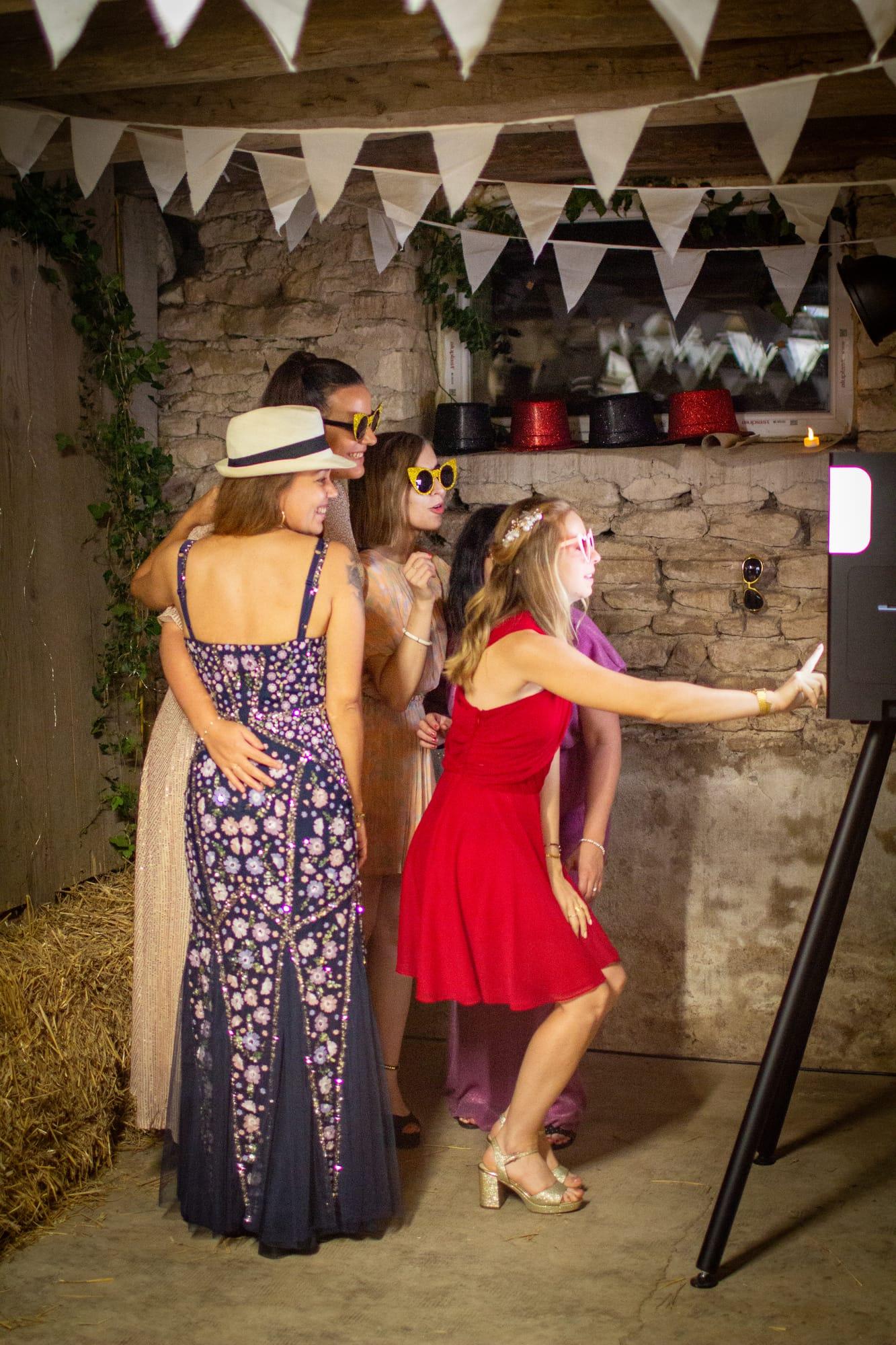 Guests laughing at the photobooth under the bunting